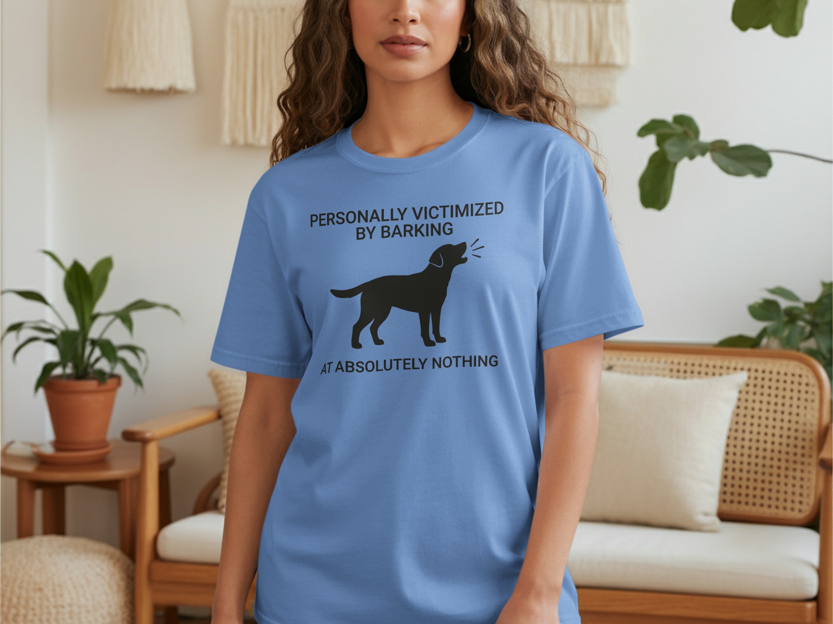Blue t-shirt with black dog silhouette and text "PERSONALLY VICTIMIZED BY BARKING AT ABSOLUTELY NOTHING".