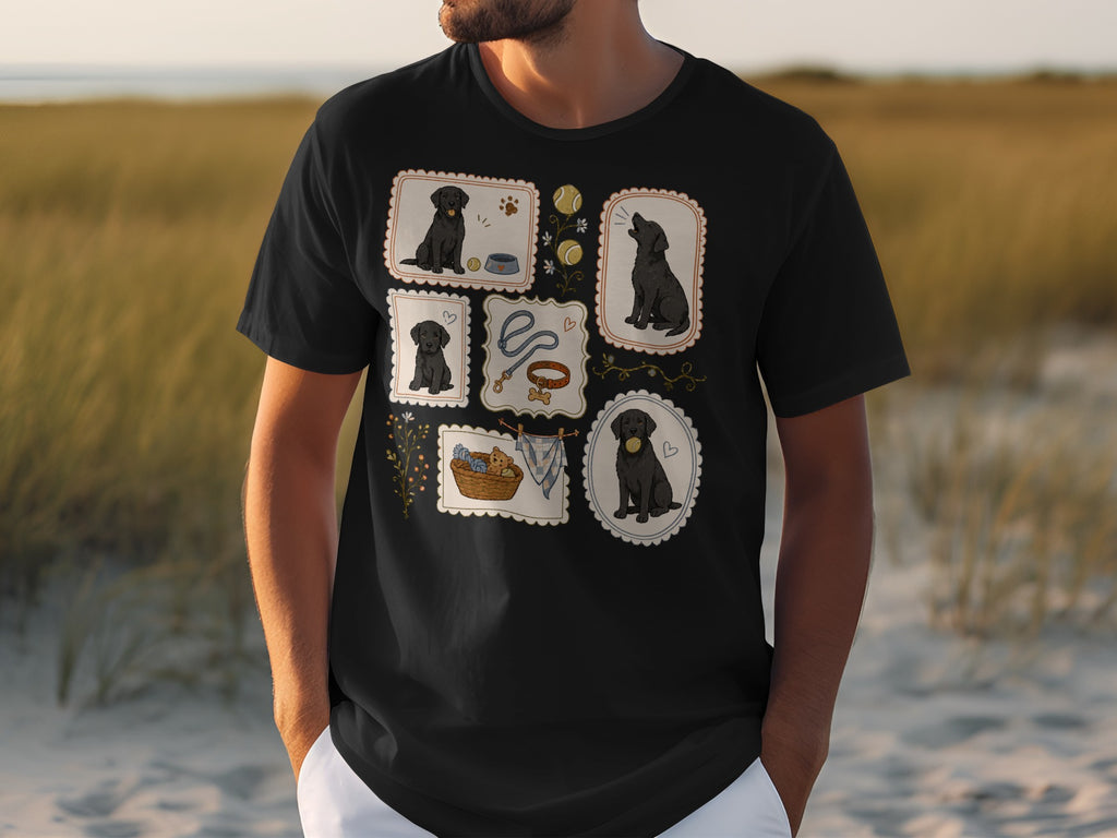 Black t-shirt with framed illustrations of black Labrador puppies playing with toys.