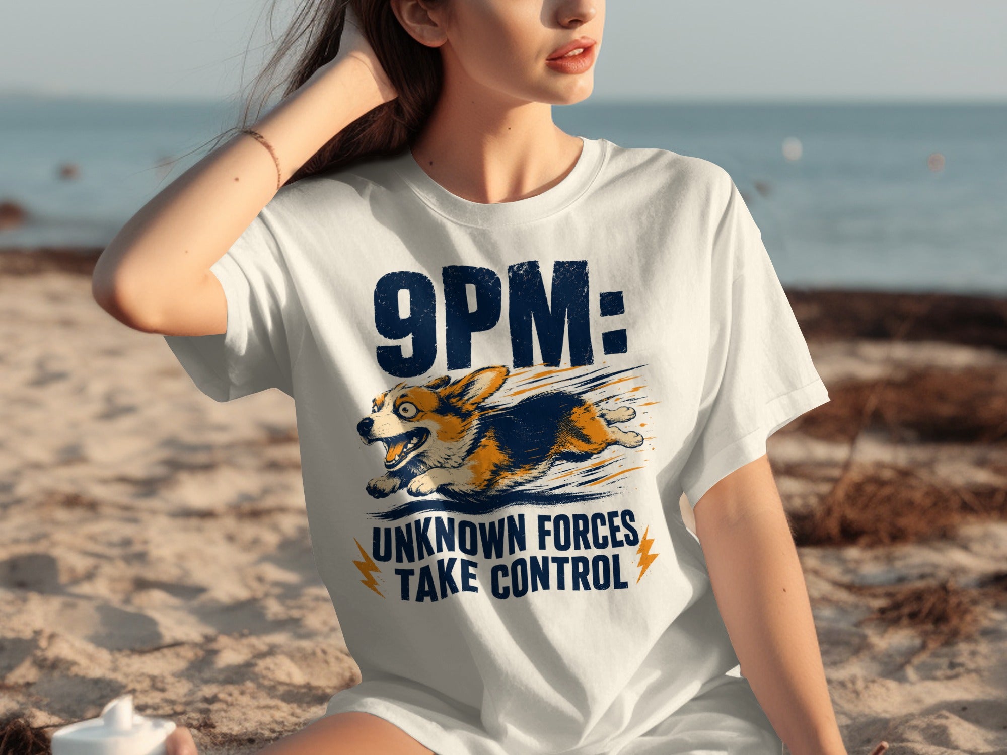 White t-shirt with a corgi and text "9PM: UNKNOWN FORCES TAKE CONTROL".