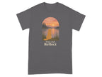 Gray t-shirt with golden retriever sitting by lake at sunset and text "Paws And Reflect".