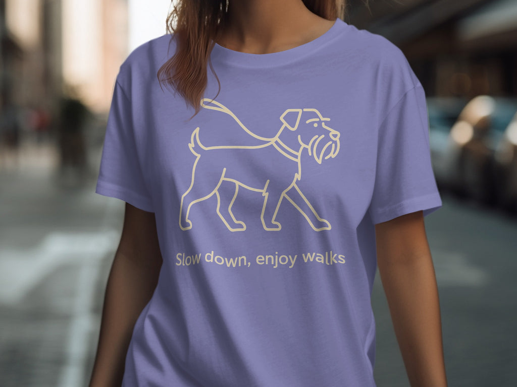 Periwinkle t-shirt with a line drawing of a dog and the text "Slow down, enjoy walks".