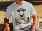 T-shirt with a pug being abducted by a UFO in a desert landscape with Joshua trees.