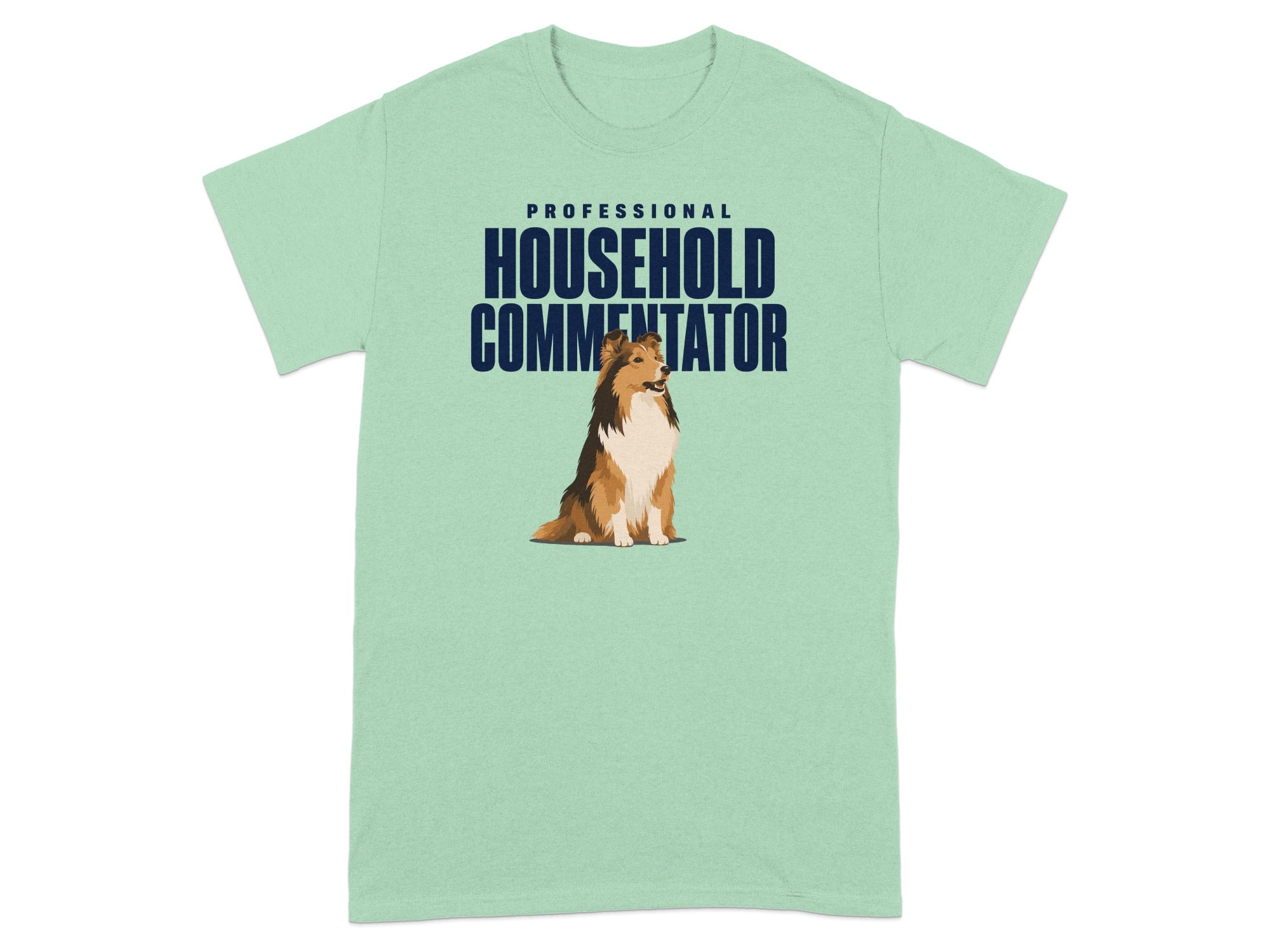 Light green t-shirt with a Sheltie dog and "PROFESSIONAL HOUSEHOLD COMMENTATOR" text.