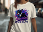 White t-shirt with a running Boston Terrier graphic and the text "Unleash the Joy".