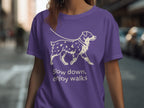 Purple t-shirt with a white outline drawing of a dog and text.