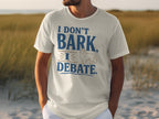 White t-shirt with "I DON'T BARK, I DEBATE" and a dog graphic.