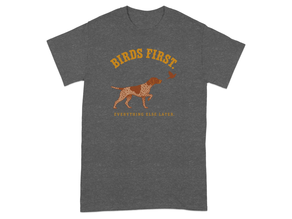 Dark grey t-shirt with a dog and bird graphic and "Birds First" text.