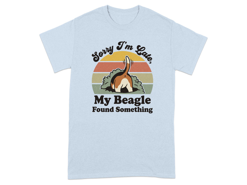 Light blue t-shirt with a cartoon beagle digging a hole and text reading "Sorry I'm Late, My Beagle Found Something".