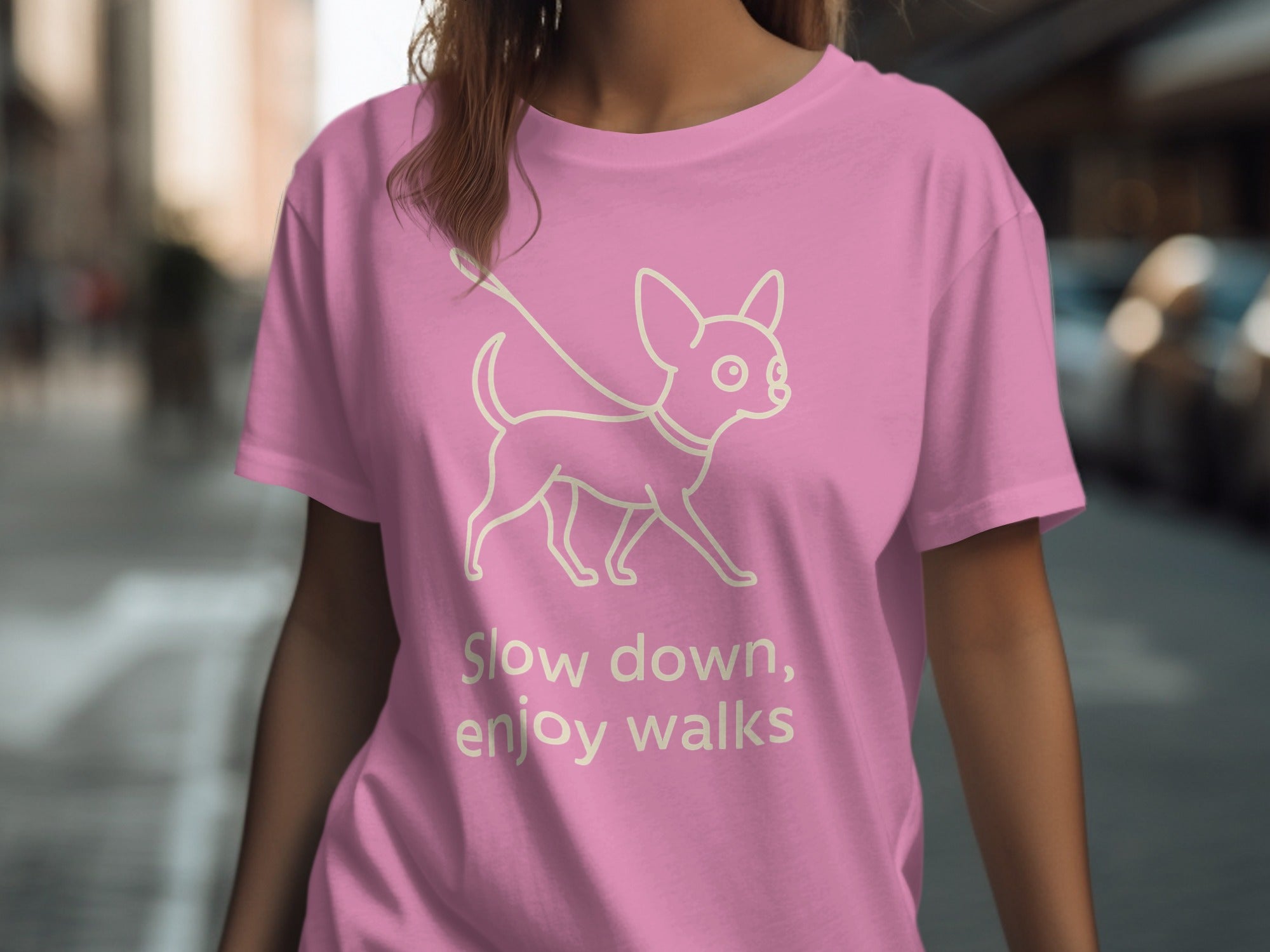 Pink t-shirt with a cream line drawing of a chihuahua and text "Slow down, enjoy walks."