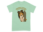 Shetland sheepdog peeking through a doorway on a light green t-shirt.