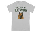 Grey t-shirt with dog portrait and text "STILLNESS IS DEEPLY SUSPICIOUS".