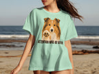 Shetland sheepdog on light green t-shirt, paw raised, "ATTENTION WILL BE GIVEN!" text.