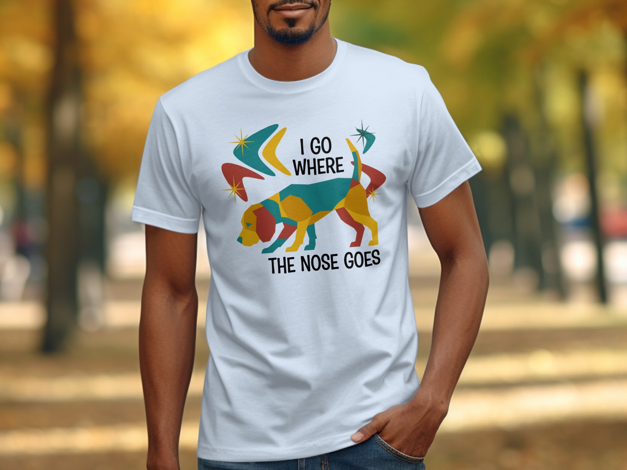 White t-shirt with colorful dog and text "I GO WHERE THE NOSE GOES."