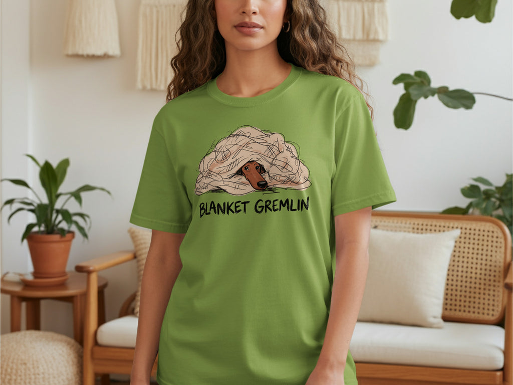 Green t-shirt with "BLANKET GREMLIN" text and dog peeking from blanket.