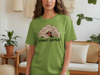 Green t-shirt with "BLANKET GREMLIN" text and dog peeking from blanket.