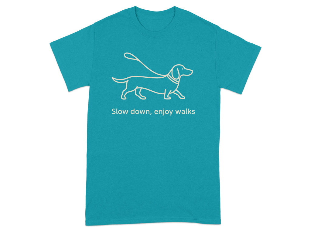 Teal t-shirt with line drawing of dachshund on leash and text "Slow down, enjoy walks".
