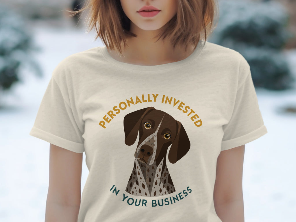 Cream t-shirt with illustration of a German Shorthaired Pointer and text "PERSONALLY INVESTED IN YOUR BUSINESS".