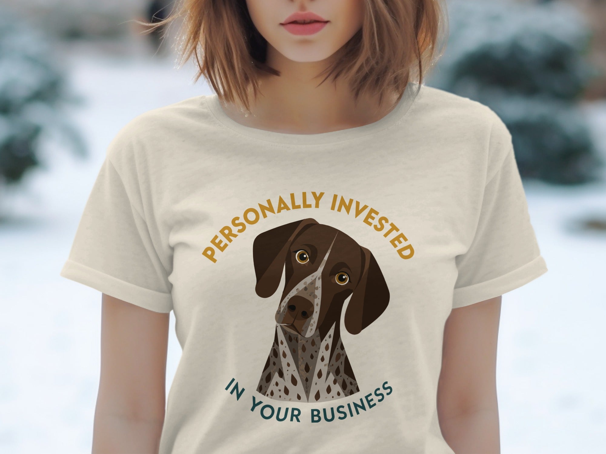 Cream t-shirt with illustration of a German Shorthaired Pointer and text "PERSONALLY INVESTED IN YOUR BUSINESS".