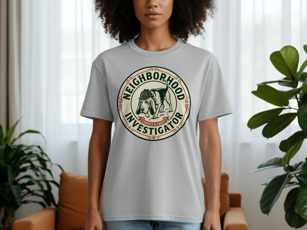 Gray t-shirt with a circular logo featuring a dog in a hat and the text "Neighborhood Investigator".