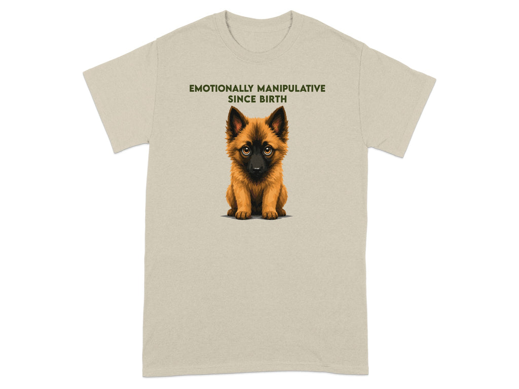 Beige t-shirt with a cartoon puppy and text "EMOTIONALLY MANIPULATIVE SINCE BIRTH".