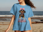 Blue t-shirt with cartoon dachshund wearing sunglasses and pink bow, text "FIRST OF ALL, I'M A DELIGHT".