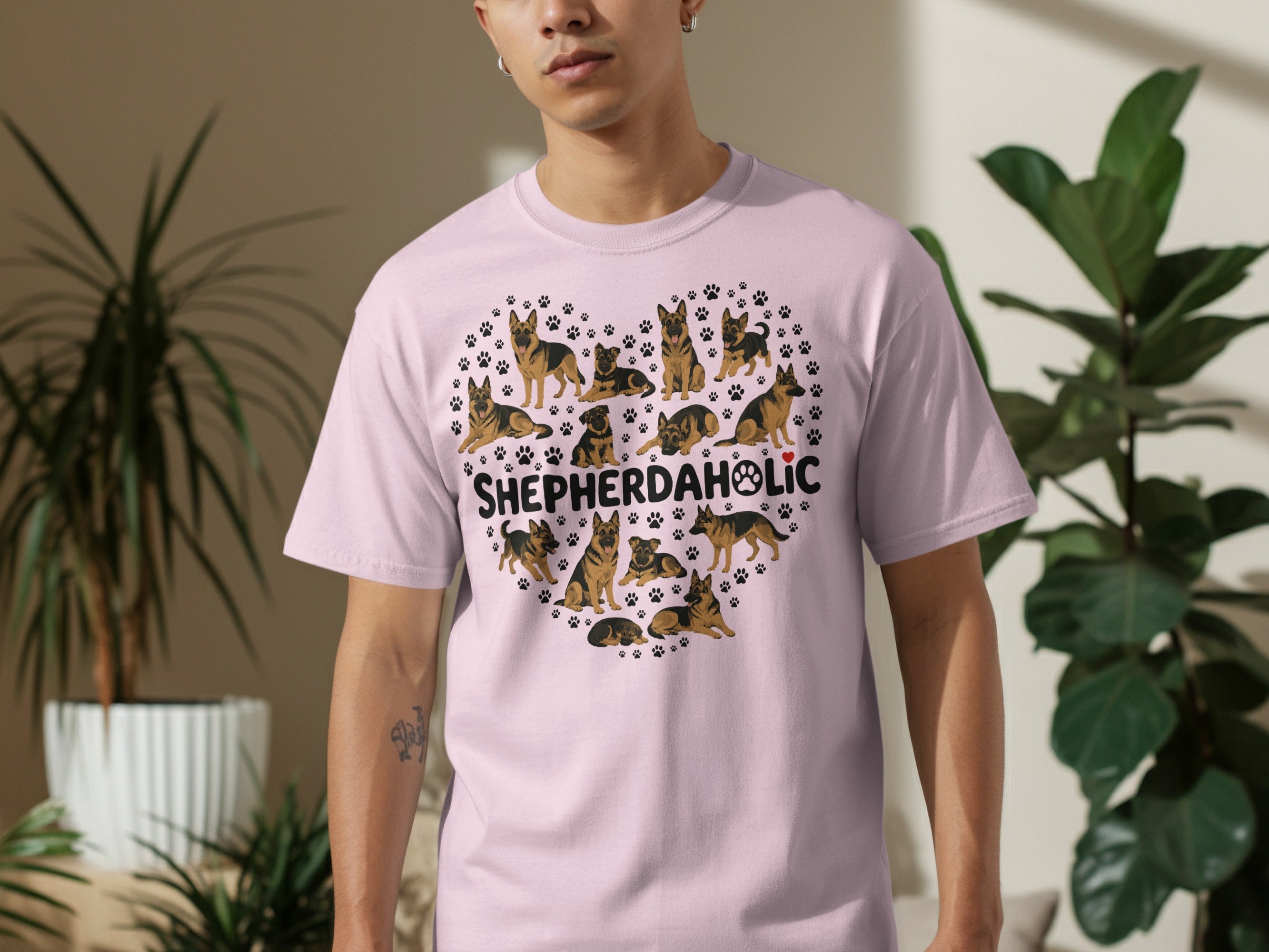 Heart shape of German Shepherd dogs and paw prints on pink t-shirt.