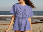 Lavender t-shirt with a line drawing of a dog and the text "Slow down, enjoy walks".