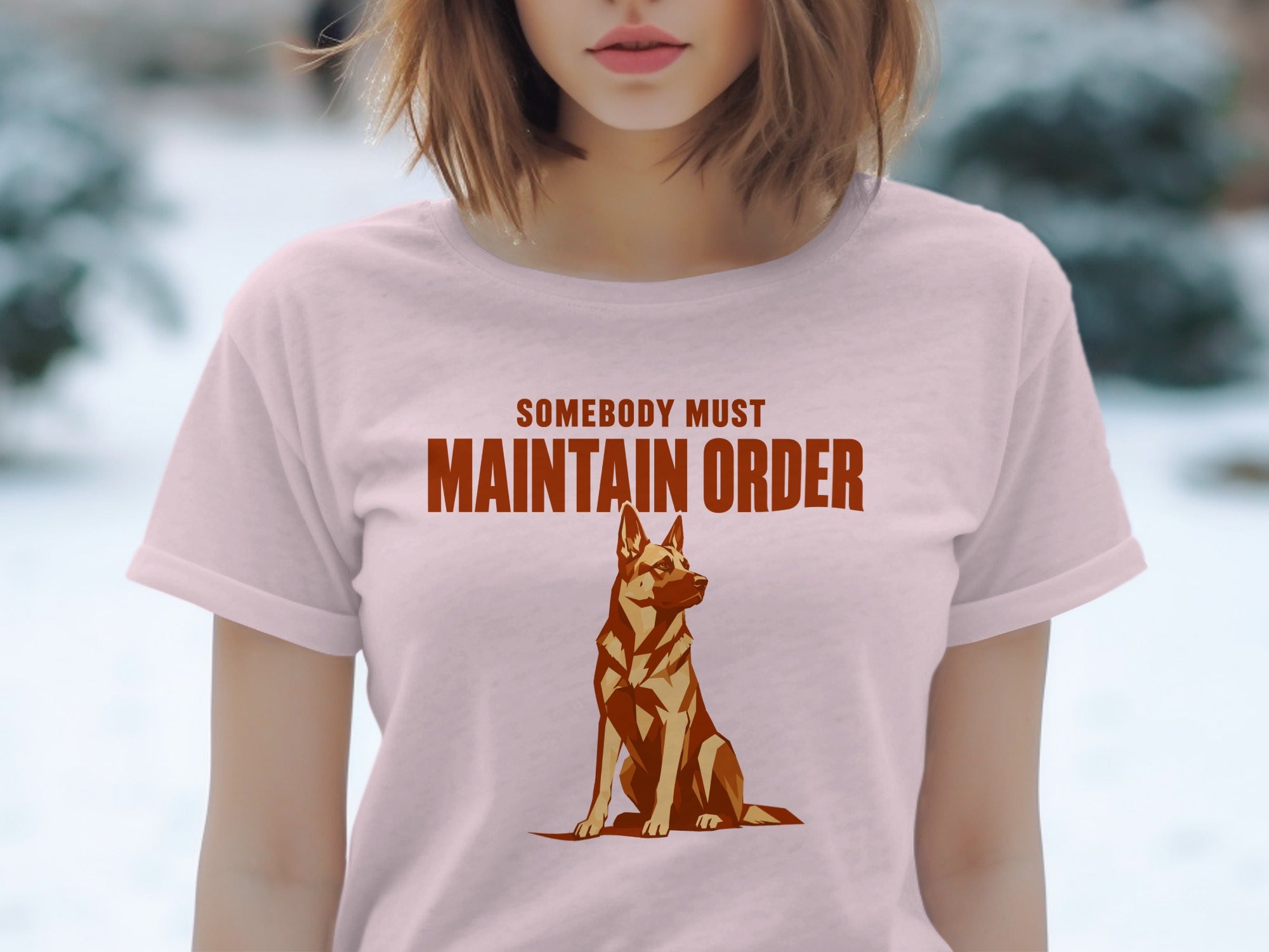 Light pink t-shirt with graphic of a German Shepherd and text "Somebody Must Maintain Order."
