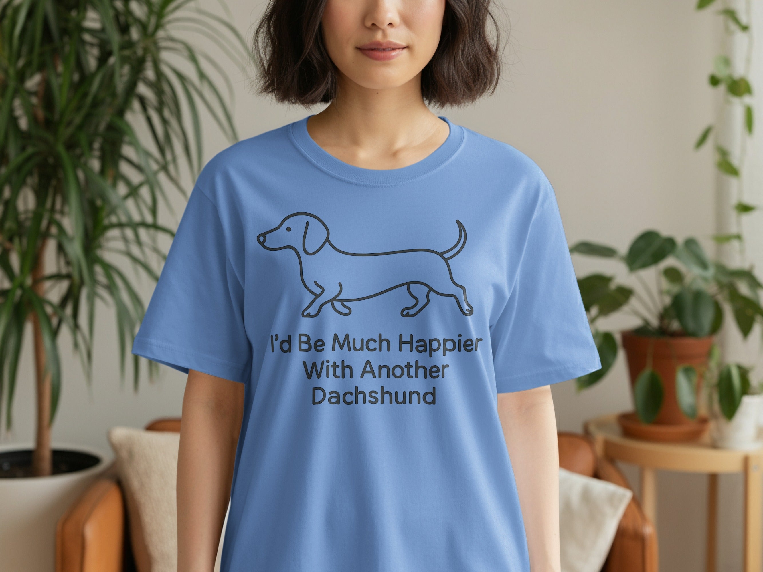 Blue t-shirt with a line drawing of a dachshund and text that reads "I'd Be Much Happier With Another Dachshund".