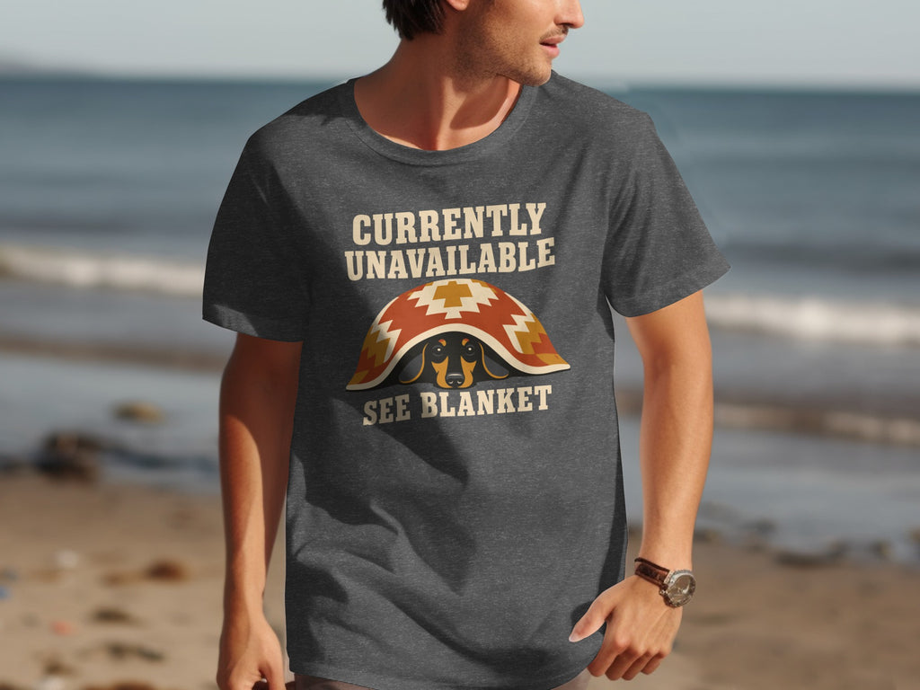 Man wearing a dark t-shirt with a dachshund under a blanket graphic.
