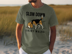 Olive green t-shirt with "SLOW DOWN ENJOY WALKS" text and a beagle.