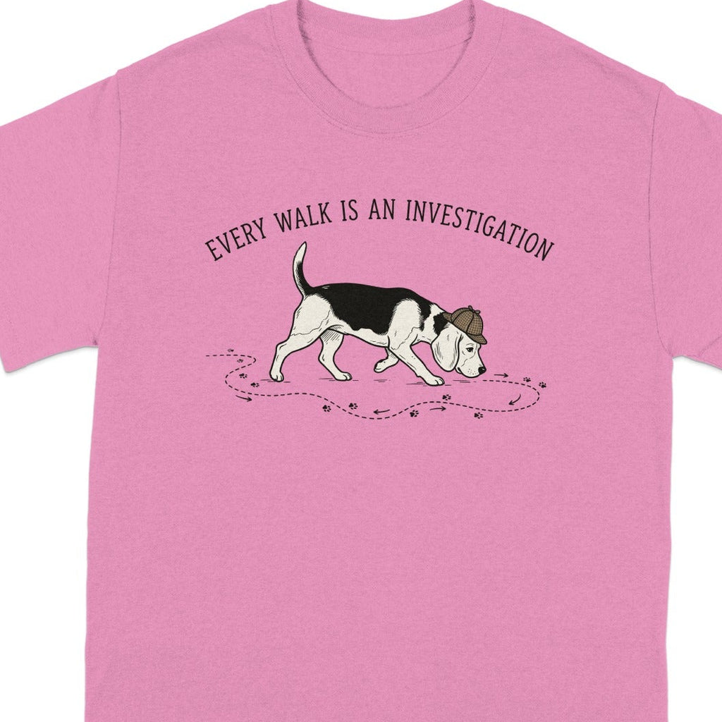 Pink t-shirt with a beagle wearing a detective hat and trailing paw prints.