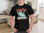 Black t-shirt showing dog on beach chair with text "Chill Out" and "Zoomies Are Inevitable".