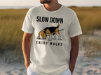 White t-shirt with a beagle and "SLOW DOWN ENJOY WALKS" text.