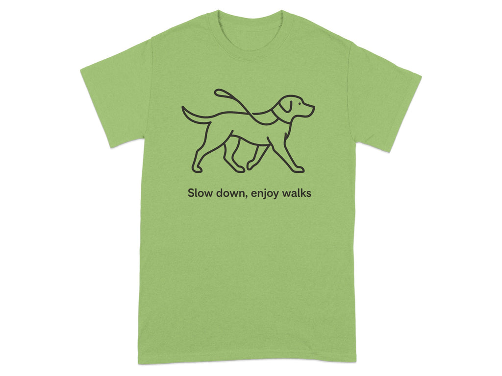 Green t-shirt with black line drawing of dog on leash and text "Slow down, enjoy walks".