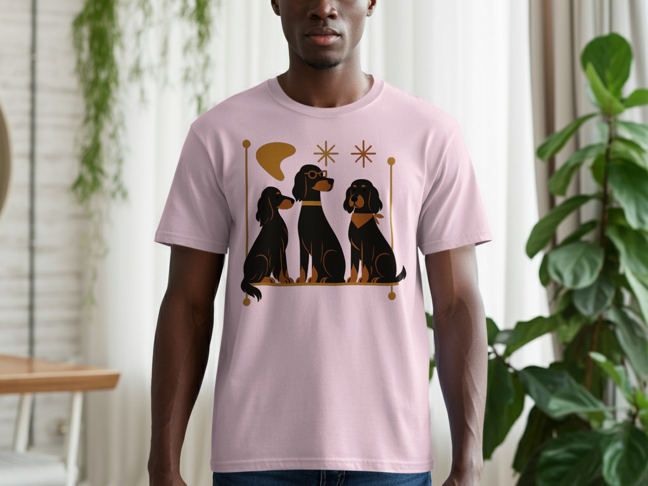 Pink t-shirt with graphic of three black dogs and retro abstract shapes.