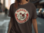 Brown t-shirt with circular "Warning Will Herd Without Notice" graphic featuring sheepdog and sheep.