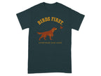 Dark t-shirt with graphic of a dog and bird, text "BIRDS FIRST. EVERYTHING ELSE LATER."