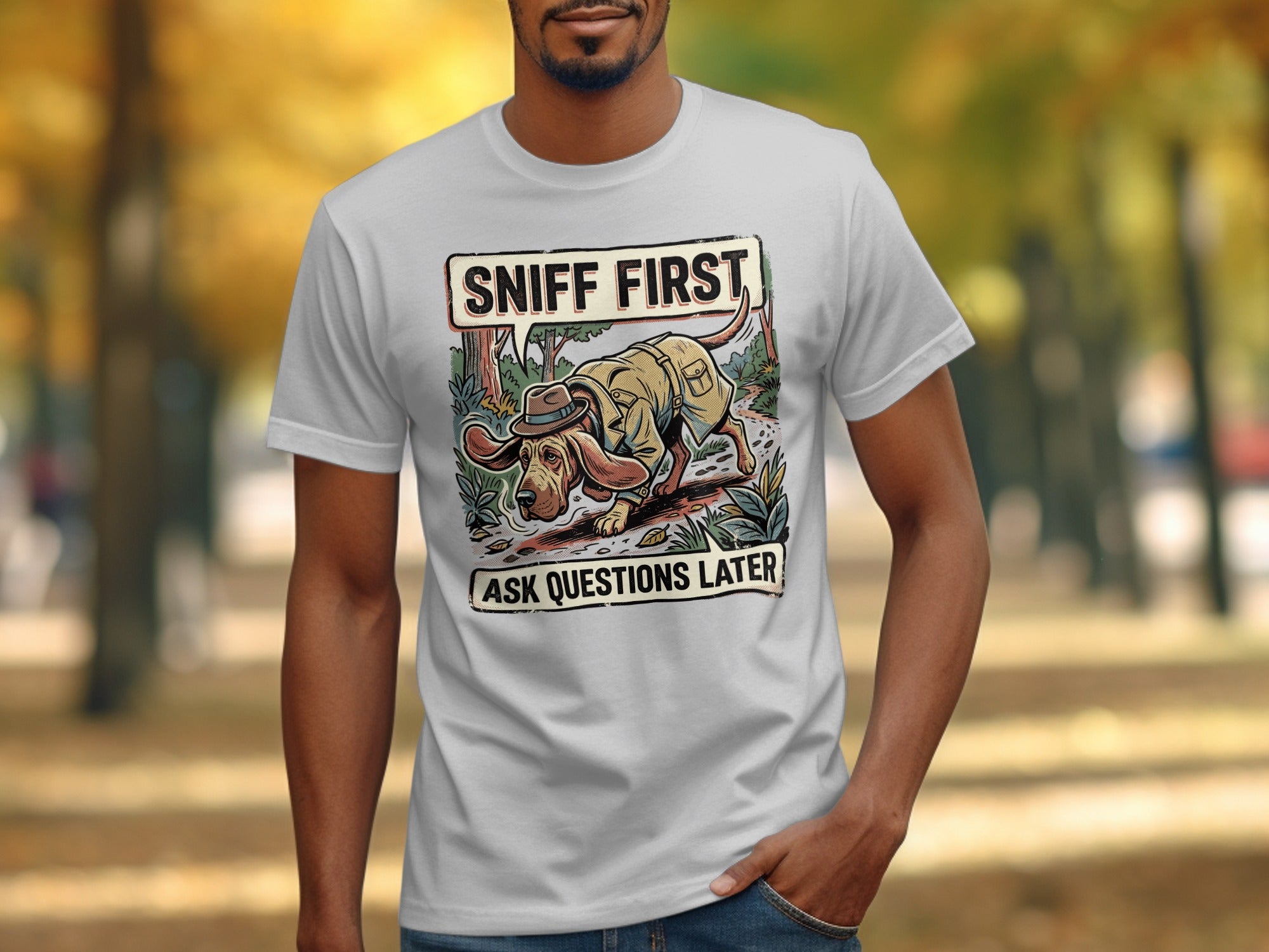 T-shirt graphic with a dog in a hat and jacket saying "Sniff First, Ask Questions Later."