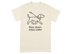 T-shirt with black line drawing of a dog on a leash and text "Slow down, enjoy walks".
