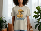Beige t-shirt with cartoon dog holding a stick and blue striped sock.