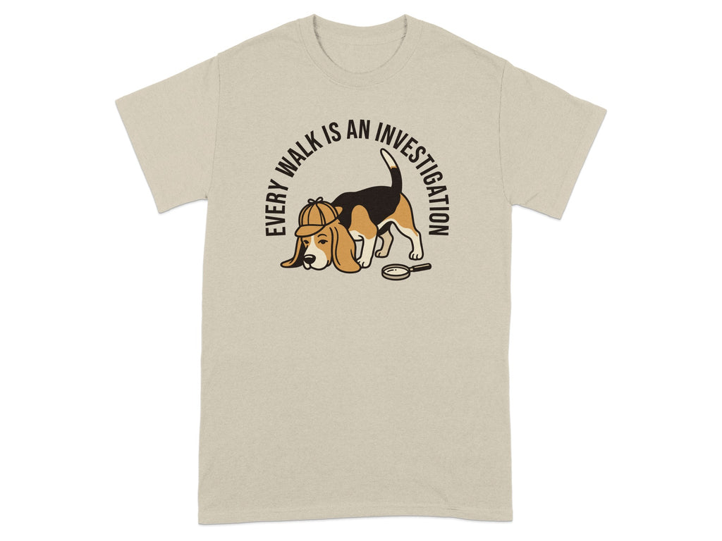 Beagle in detective hat and magnifying glass on beige t-shirt.