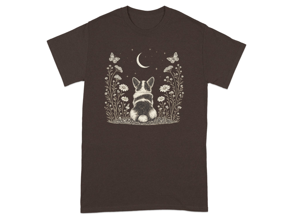Brown t-shirt with a drawing of a corgi sitting in a meadow under a crescent moon.