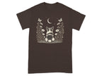 Brown t-shirt with a drawing of a corgi sitting in a meadow under a crescent moon.