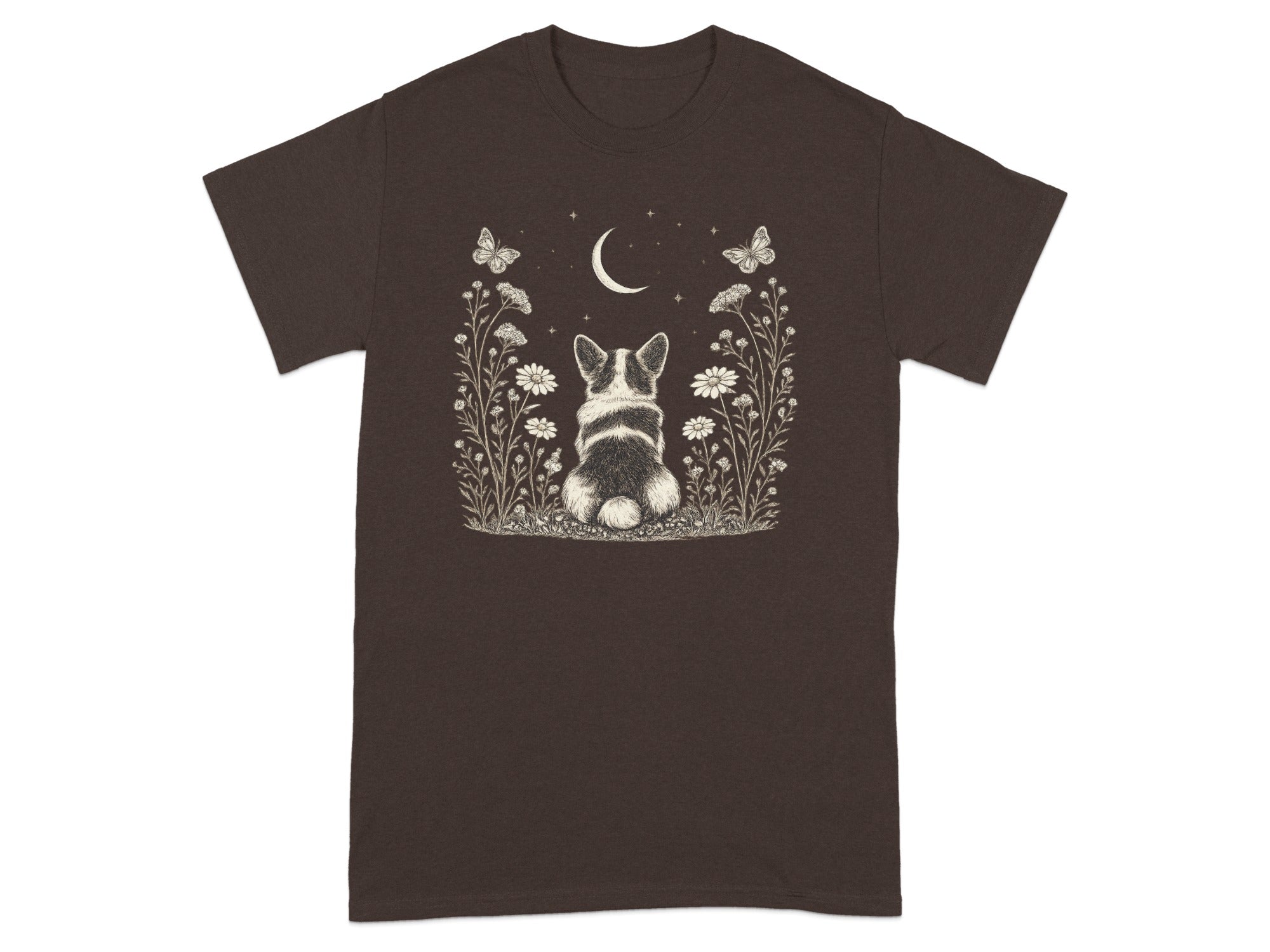 Brown t-shirt with a drawing of a corgi sitting in a meadow under a crescent moon.