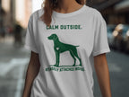 Green dog silhouette with heart on white t-shirt, text "CALM OUTSIDE. INTENSELY ATTACHED INSIDE."