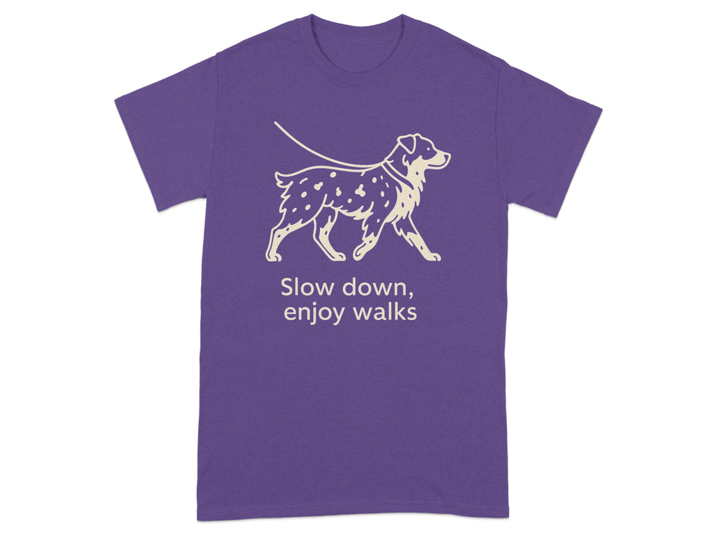 Purple t-shirt with a graphic of a dog on a leash and text "Slow down, enjoy walks."