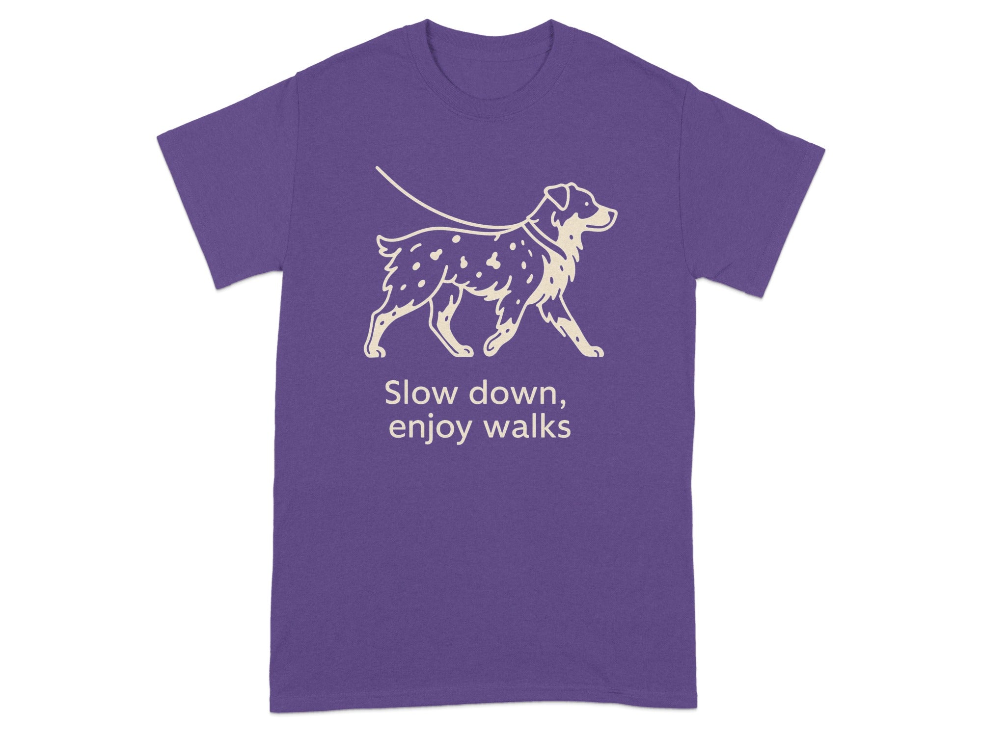 Purple t-shirt with a graphic of a dog on a leash and text "Slow down, enjoy walks."