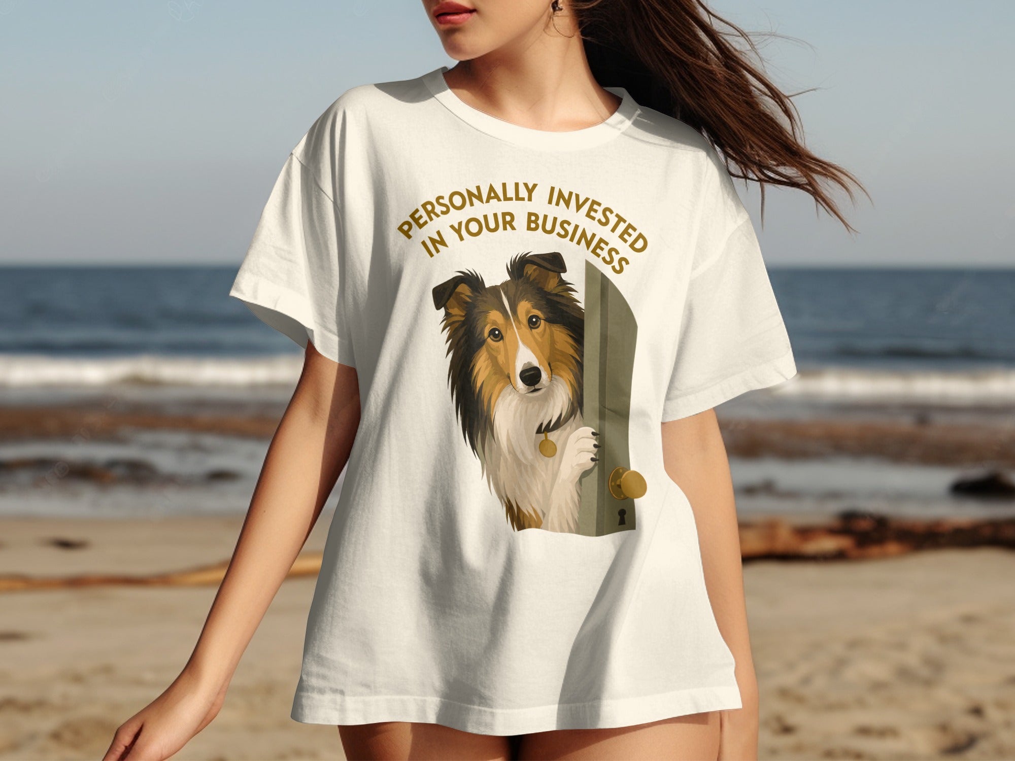Shetland sheepdog peeking through an open door on a white t-shirt.