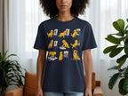Dark blue t-shirt with a graphic of golden retrievers painting with paw prints and brushes.